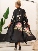 robe kimono preto floral de pé apoiado mão no laço pose elegante